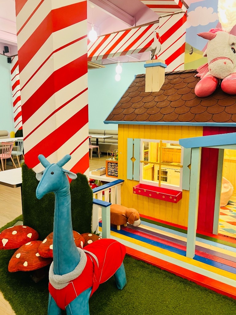 Playhouse at Charlie Restaurant, with candy-stripe columns and the dining room in the background