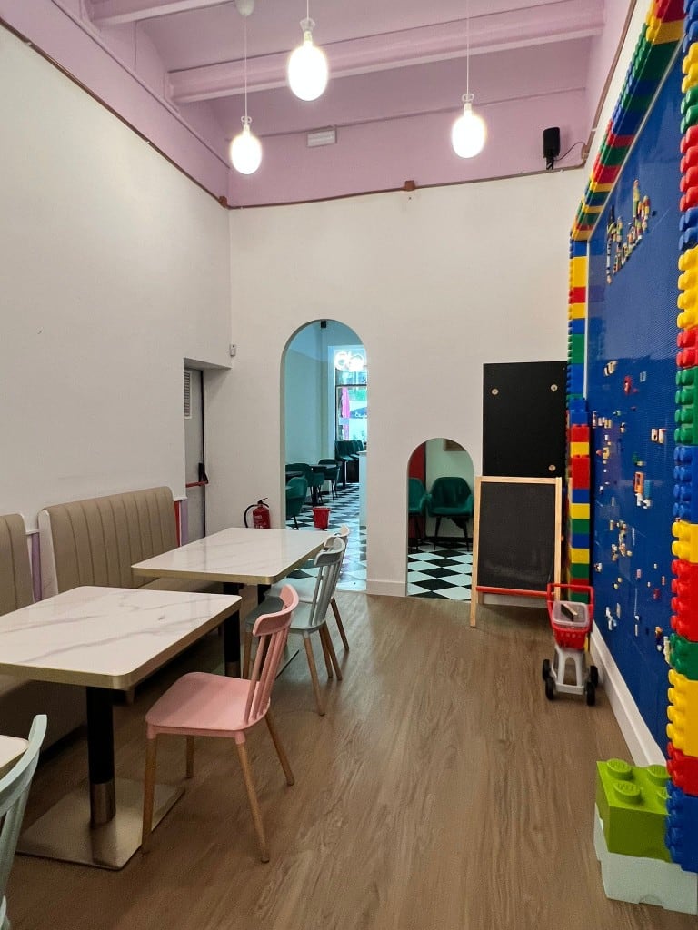 Dining room at Charlie beside the building-block wall and a child-sized arch