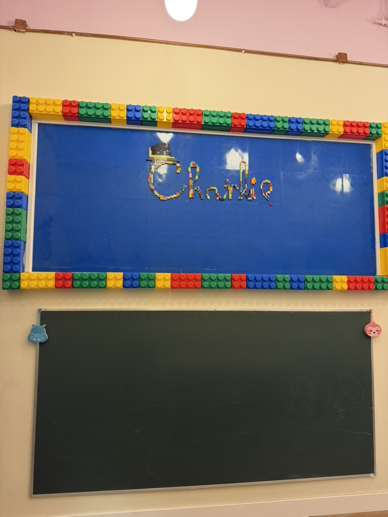 Building-block wall with the name Charlie in the play area
